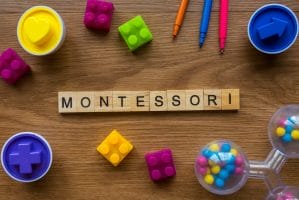 An image of Montessori on wooden alphabet concept with toys on wooden background.