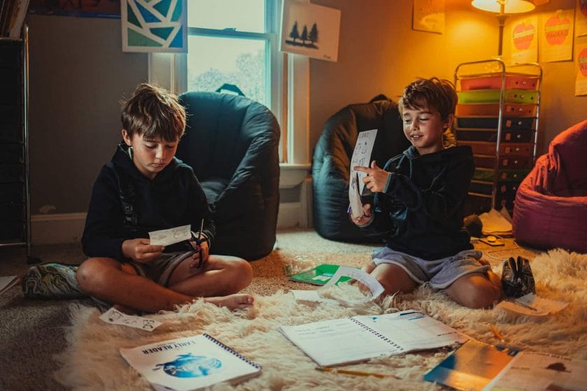 An image of Twin brothers having fun homeschooling.