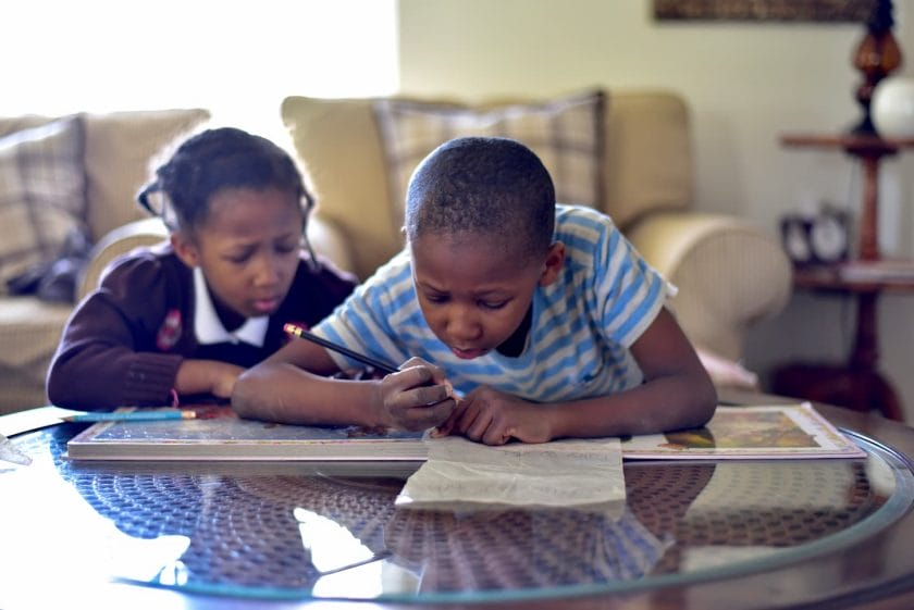 An image of Kids doing schoolwork at home.