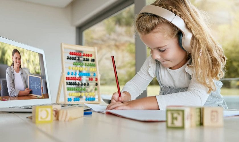 An image of a Virtual class, learning math, and a student studying on an educational webinar, learning on a video call, and writing notes.