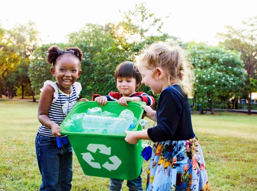 An image of a Group of kids volunteering for a charity movement about the environment.