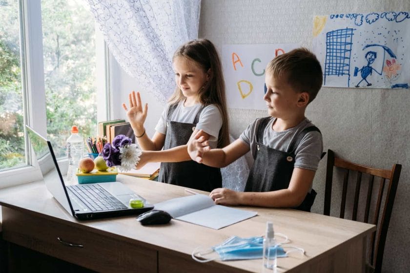 An image of Schoolkids boy and girl using the laptop for online study during homeschooling at home.